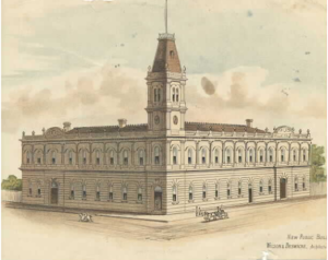 Hand-coloured illustration of the proposed exterior view of the Malvern Shire Hall, 1885, at the corner of Glenferrie Road and High Street. The drawing has one corner tower with a flag pole a clock at its base. The lower storey windows are arched and the pediments are semi-circular. The building, which was completed the following year, was not built with all of these features. People, horses and a carriage are drawn by the Shire Hall building drawing is labelled 'New Public Buildings, Malvern'. Wilson & Beswicke, architects.