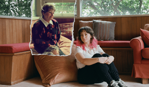 A photo of a young woman sitting on the floor next to a couch. Another photo, of an older women, is overlaid onto the photo so we can see it was taken in the same room, sitting on the couch.