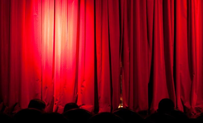 Photo of closed red velvet theatre curtains